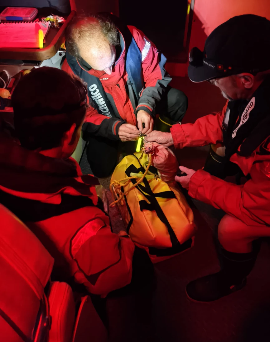 Coastguard Raglan volunteers onboard Gallagher Rescue vessel prepare dry bag of warm gear and supplies to throw ashore PHOTO COASTGUARD RAGLAN